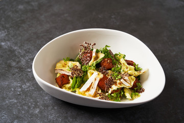 Baked Pumpkin salad with baked cheese, parsley herbs, white cabbage