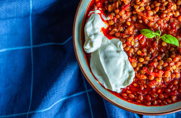 Close up shot of traditional turkish lentil dish and a spoon of yoghurt