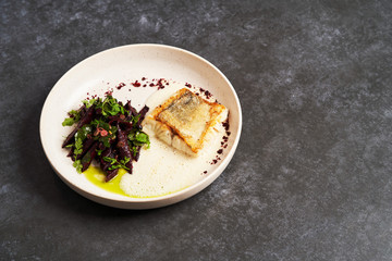Fried fish perch with vegetables on a white table on grey table