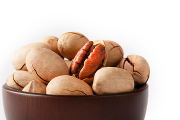 Pecan in a wooden Cup isolated on a white background. Isolate.