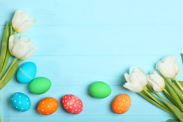 Easter eggs and flowers on the table top view. Easter composition with a place to insert text.