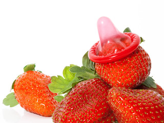 Unwrapped color condom with fruit flavor and strawberries
