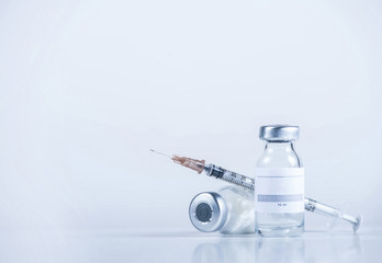 Medical tube with medicine and empty place for text and syringe close-up. Copy space.