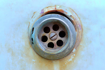 rusty drain in the old, cracked tub, cracked clogged, broken old bathroom drain