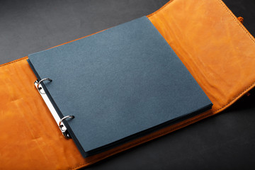 Photo album with blank black for photos. Split rings for close-up macro albums.The album cover is made of brown handmade genuine leather on a black background.
