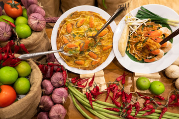 Pad thai fresh prawn or Thai seafood noodles and crispy fried mussels recipe delicious food good taste local street food in Asian Thailand with spicy ingredients including red chilli, lime and garlic