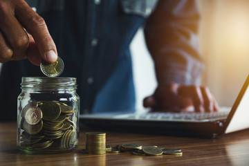 Hand drop a coin with money coin stack growing for business. financial and accounting concept.