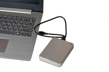 Isolate on a white background laptop and external hard drive. Information Technology. Computer technology.