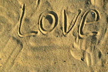 Word love in the sand on beach