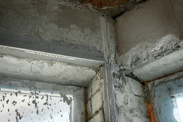 The plasterer repairs the corners of the window with a spatula and plaster. Construction finishing works.
