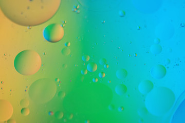 Oil drops in water. Abstract defocused psychedelic pattern image rainbow colored. Abstract background with colorful gradient colors. DOF.