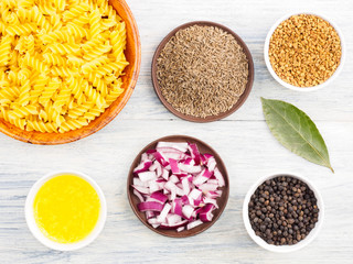 Ingredients for cooking pasta: black pepper, onion, bay leaves, fenugreek, cumin (jeera), butter (ghi). Healthy eating concept