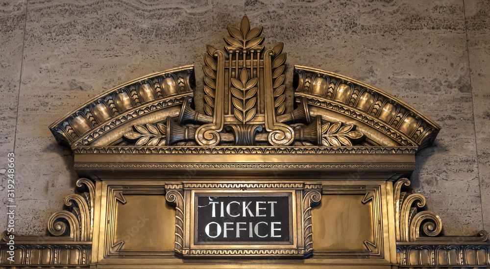 Wall mural ticket office ornate bronze sign against a brown marble wall in chicago's civic opera house