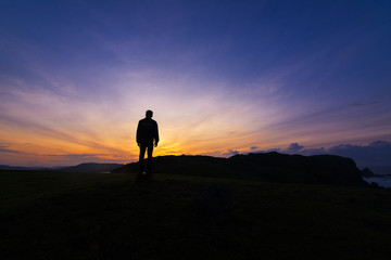 silhouette of a man on top of the mountain