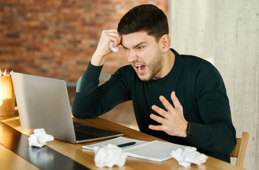 Fototapeta premium Angry Businessman Shouting Crumpling Paper Sitting In Modern Office