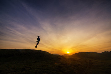 silhouette of man on top of mountain