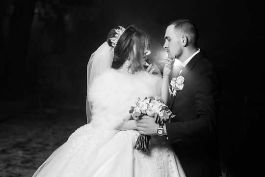 Happy couple. Wedding photo. Couple in love. Bride and groom in a park kissing. Couple newlyweds bride and groom are kissing photo portrait. Wedding Couple in winter. Black and white photo