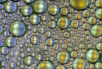 Oil and water abstract macro texture in blue and gold as a background