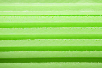 Background soft foam insulation sheets lie on top of each other with lines of different shades of...