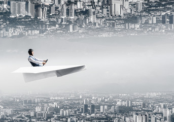 Happy aviator driving paper plane