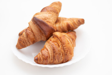Croissants on a white plate. Breakfast is delicious and healthy.