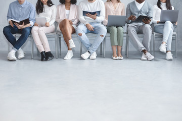 Casual people sitting in line, waiting for interview