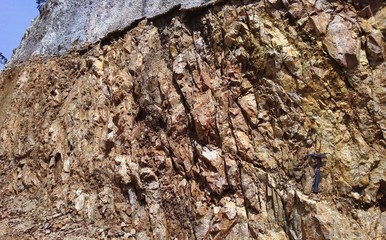 Rocks outcrop with geology hammer