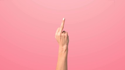 The female hand shows the middle finger. The girl raises her hand in the frame showing the middle finger and shaking it