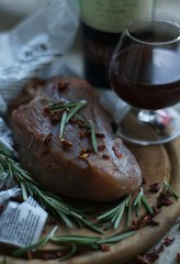 raw meat with rosemary, spices and red wine