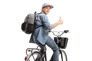 Guy riding a bicycle and holding his thumb up