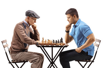 Senior man and a young man playing chess