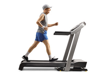Active senior man walking on a treadmill