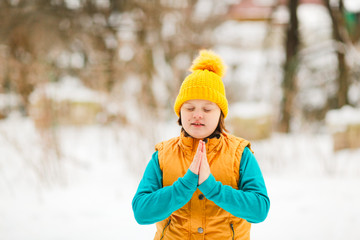 girl kid in yellow hat in asana practices yoga