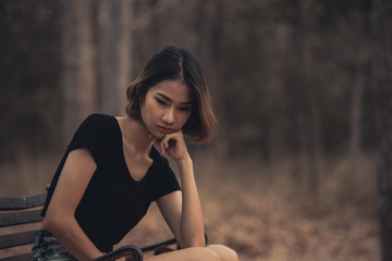 Asian beautiful girl feel alone in the forest,Sad woman concept,Thailand people,Lady sadness about love from boyfriend,She feeling broken heart