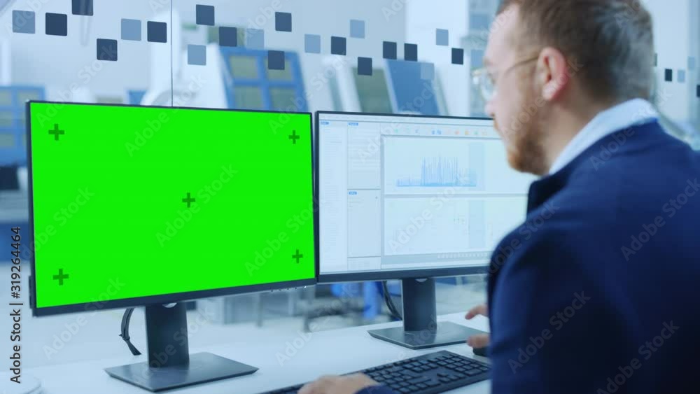 Aufkleber Industrial Engineer Working on a Personal Computer, Two Monitors Show Green Screen Display and CAD Software with 3D Eco Engine Being Tested. Working Modern Factory. Camera Zoom in on Display