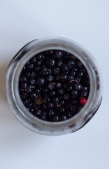 Jar with blueberries on the table.