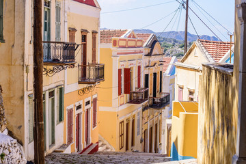 Traditional street in Symi old town with beautiful old houses, Symi island, Dodecanese, Greece