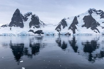Fototapeta na wymiar Mountains reflected in ocean near Lemaire Channel, Antarctica