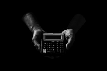 a calculator in a hand in the dark. - Saving money for finance accounting concept.
