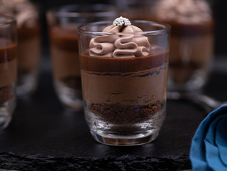 Chocolate mousse in glasses topped with whipped cream