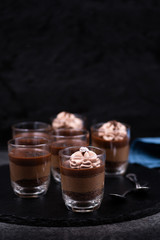 Chocolate mousse in glasses topped with whipped cream