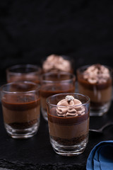 Chocolate mousse in glasses topped with whipped cream