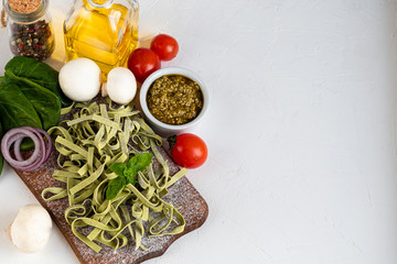 Fototapeta na wymiar Pasta, vegetables, herbs and spices, olive oil, ingredients for Italian cuisine against white background.