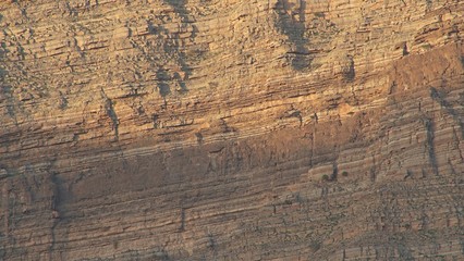 Sunlights on mountain canyon, Stone texture on a mountain face in early morning light, sedimentary mountain limestone rocks texture