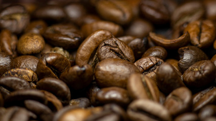 Coffee in beans on dark background. Abstract background texture.Coffee beans texture. Food background of coffee beans