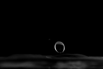 Water splash isolated, water drop hit the surface, water droplet falling and hitting water surface and causing a rebound and explosion