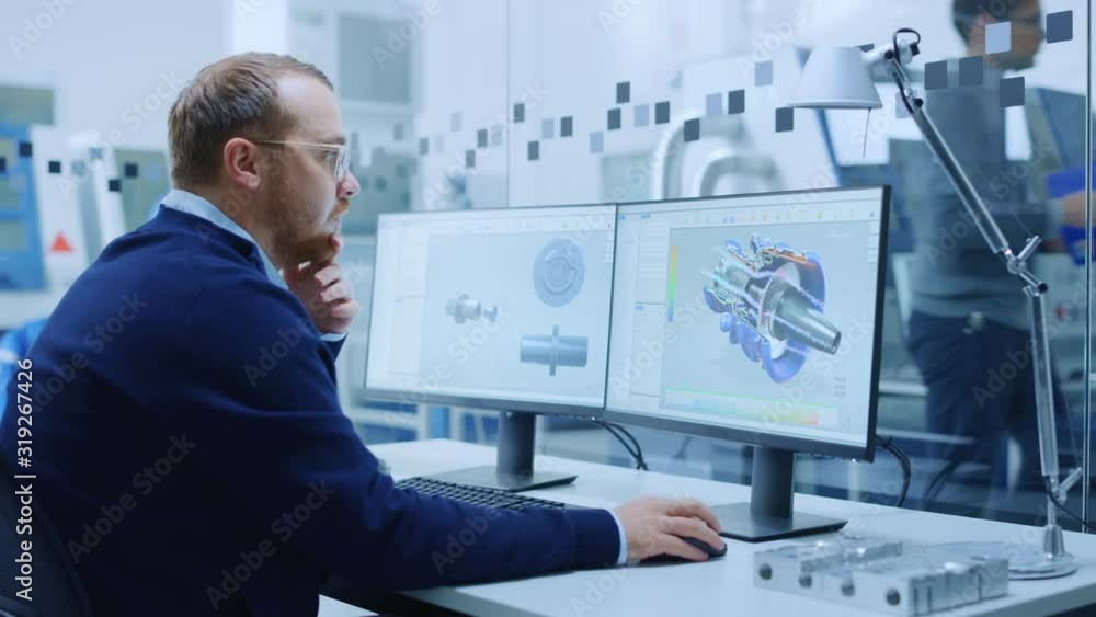 Poster Male Industrial Engineer Solving Problems, Working on a Personal Computer, Two Monitor Screens Show CAD Software with 3D Prototype of Hybrid Electric Engine Being Tested. Working Modern Factory