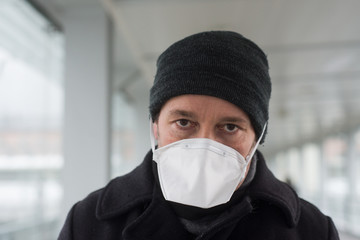 Portrait of man with medical mask protection againt the coronavirus