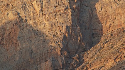 Sunlights on mountain canyon, Stone texture on a mountain face in early morning light, sedimentary mountain limestone rocks texture