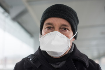 Portrait of man with medical mask protection againt the coronavirus